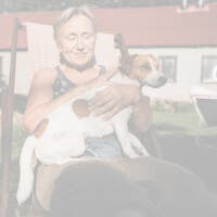 Woman relaxing with dog outdoors