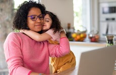 Mother with daughter looking at laptop